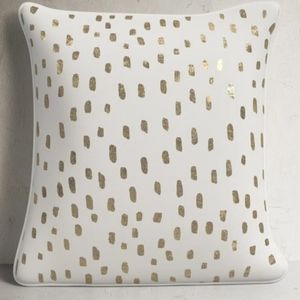 2 white and gold throw pillows